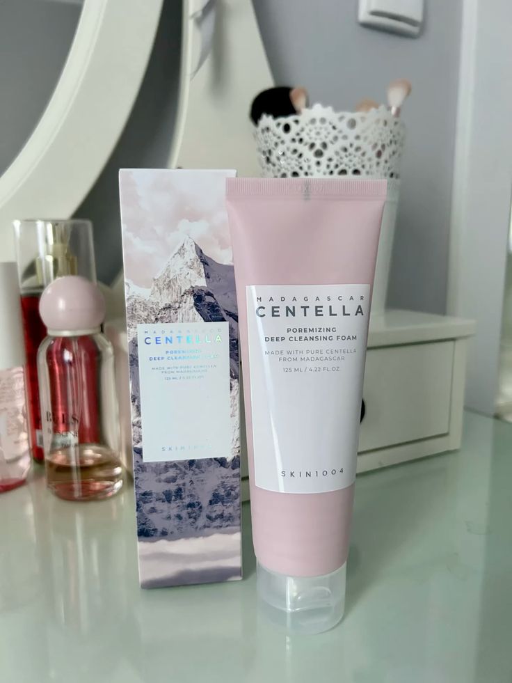 SKIN1004 Madagascar Centella Poremizing Deep Cleansing Foam in pink tube with box packaging, Korean skincare facial cleanser displayed on vanity.